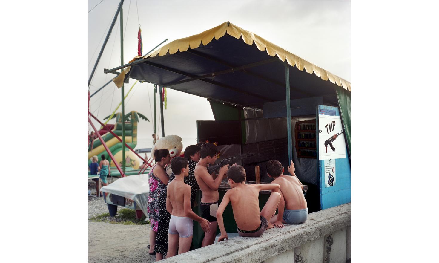 Kids playing at a shooting game on Sukhum(i) Beach.