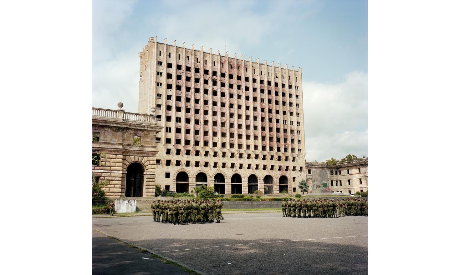 The parade rehearsal of twenty years of Abkhazia's independence take place in front of the former parliament of Sukhum(i) which was occupied and burnt by Georgians during the war.