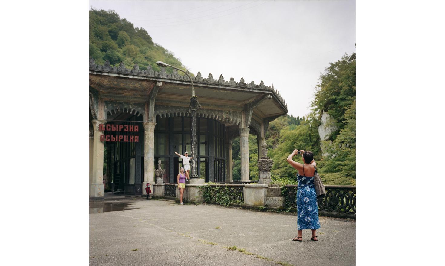Above the New Athos Monastery. The Russian tourists take photos in front of a former train station, closed down since the war.