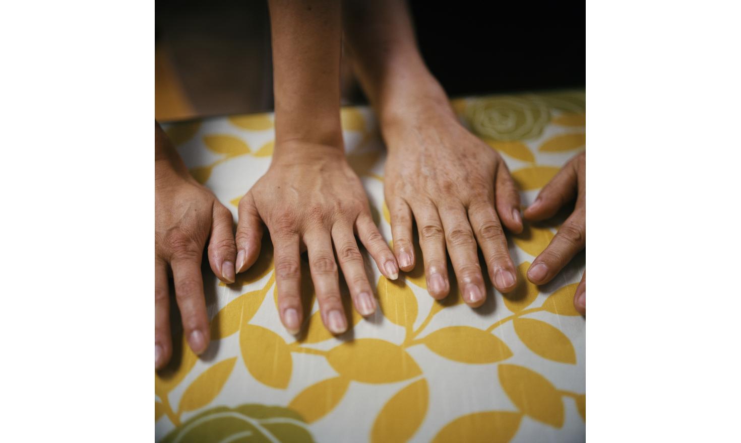 © Agnès Dherbeys / MYOP 4th of July 2013Mrs. Yang and Laure, her daughter adopted in France compare their hands. Excerpts of a letter from Laure to Agnès Dherbeys: "It took me some time to give her a name that would please me, because I canât either call her mother, nor mummy